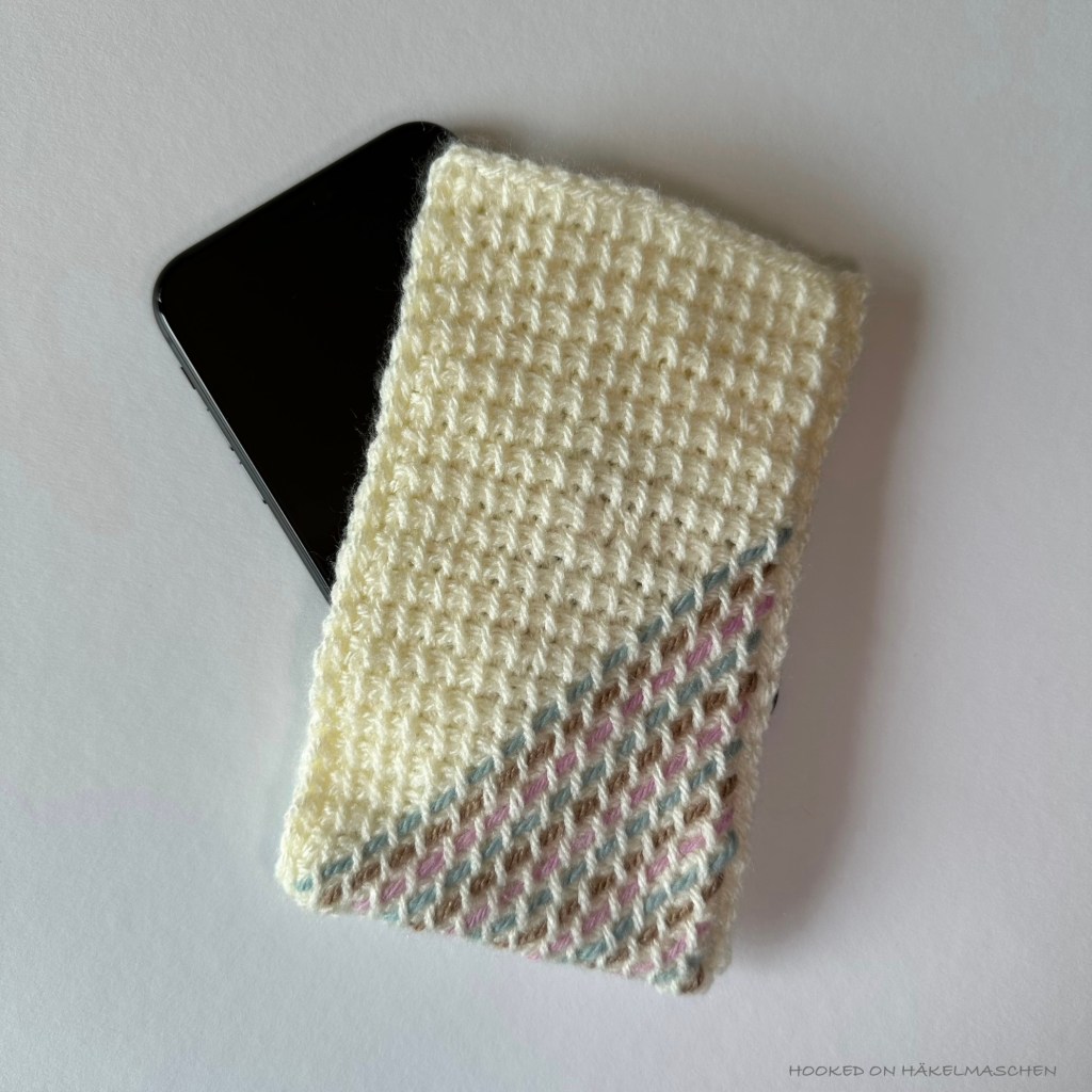Tunisian crochet, cover for a mobile phone made in Tunisian Simple Stich, decorated with simple embroidery